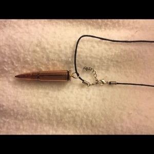 Brass-colored bullet necklace.